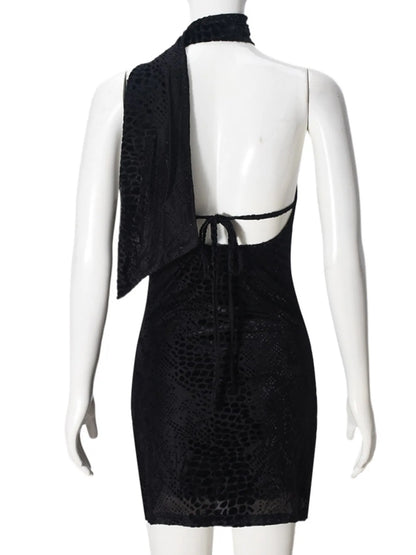 Back view of black asymmetrical halter mini dress with open back on a mannequin against a white background
