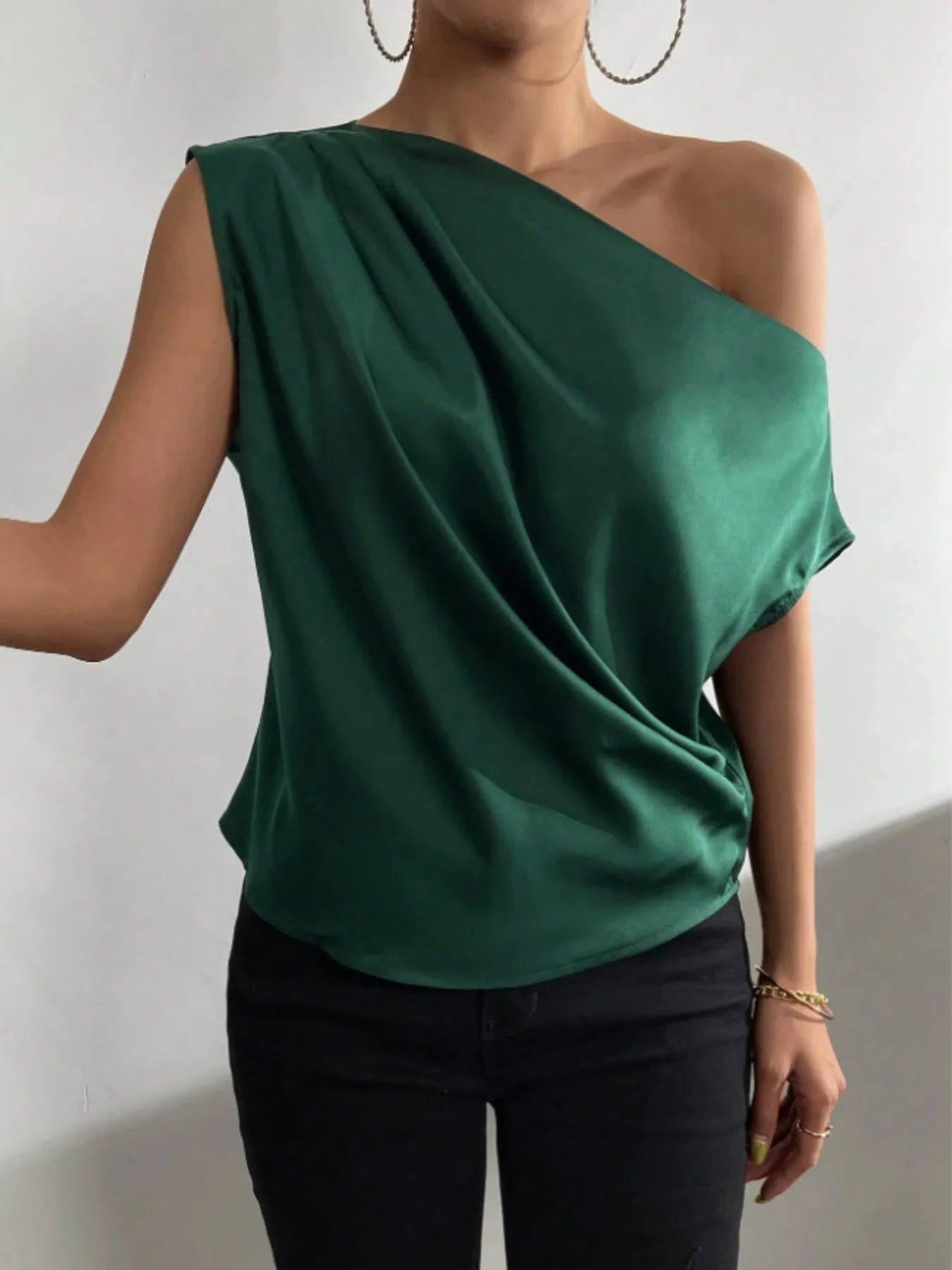 Green Asymmetrical One-Shoulder Draped Blouse worn by a woman against a plain background