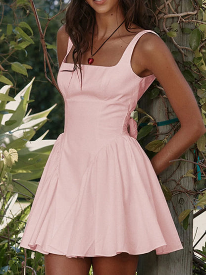 Model wearing pink square neck open-back mini dress front view