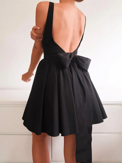 Model wearing black square neck open-back mini dress back view 