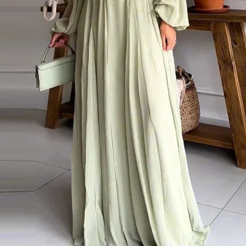 close up of flowy maxi skirt of off shoulder light green / sage backless dress 