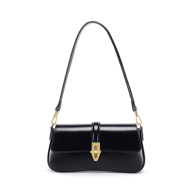 Black genuine leather handbag with gold accents on a white background
