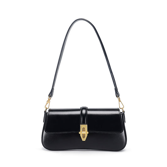 Black genuine leather handbag with gold accents on a white background