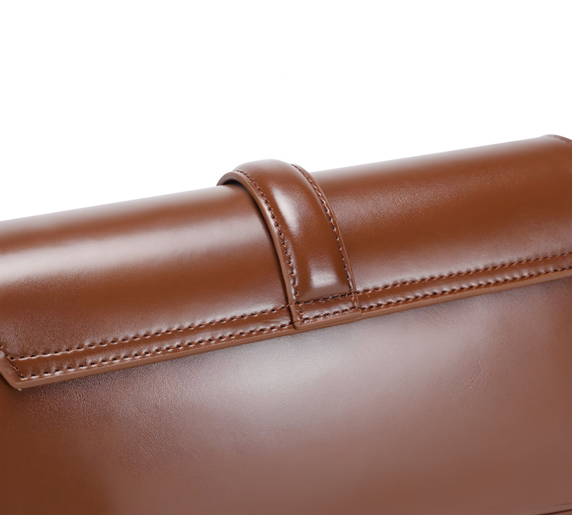 Close-up of back of a brown genuine leather baguette bag with visible stitching on a white background
