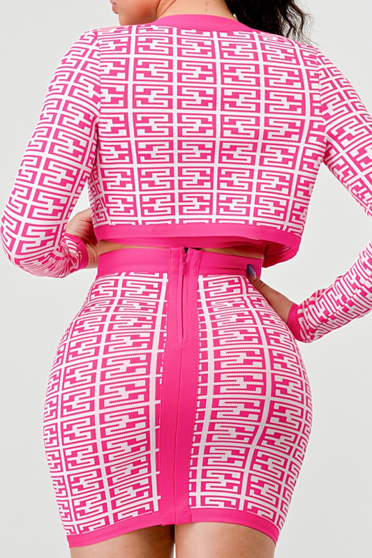 Model wearing pink printed three-piece bandage set with long sleeve top, crop, and skirt back view 