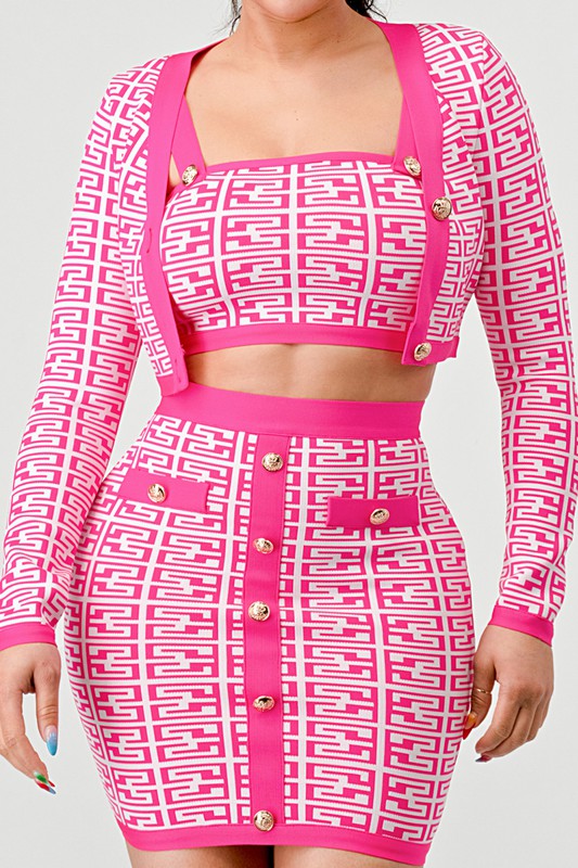 close up front view of pink printed bandage three piece set for women showcasing crop top and long sleeve seater with high waisted skirt 