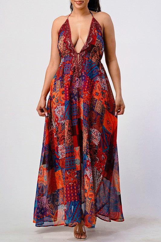 woman wearing a backless boho chic maxi dress in jewel-tone patchwork print with halter tie