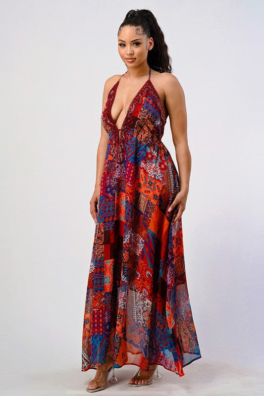 woman wearing a bohemian sequin lace maxi dress with plunging halter neckline and flowing silhouette