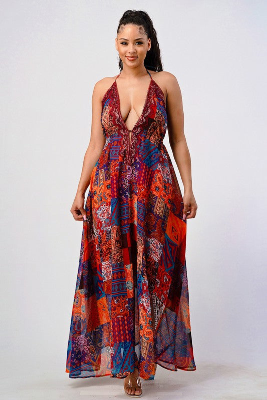 woman wearing a luxury bohemian sequin lace maxi dress with plunging halter neckline and flowing silhouette