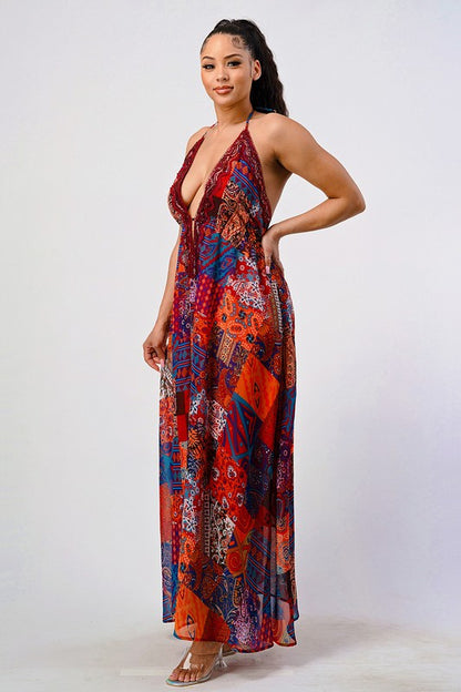 side view of woman wearing backless boho chic maxi dress in jewel-tone patchwork print with halter tie