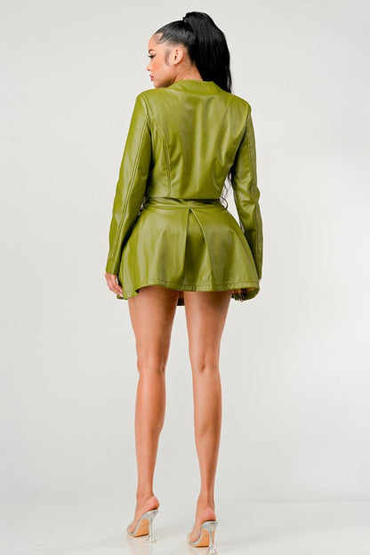 Back view of woman wearing a green Women’s luxury vegan leather two-piece outfit