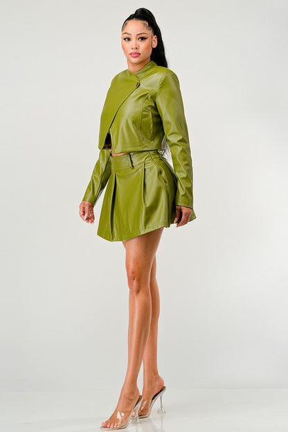 Side view of woman wearing a green high-fashion streetwear PU leather co-ord on a white background