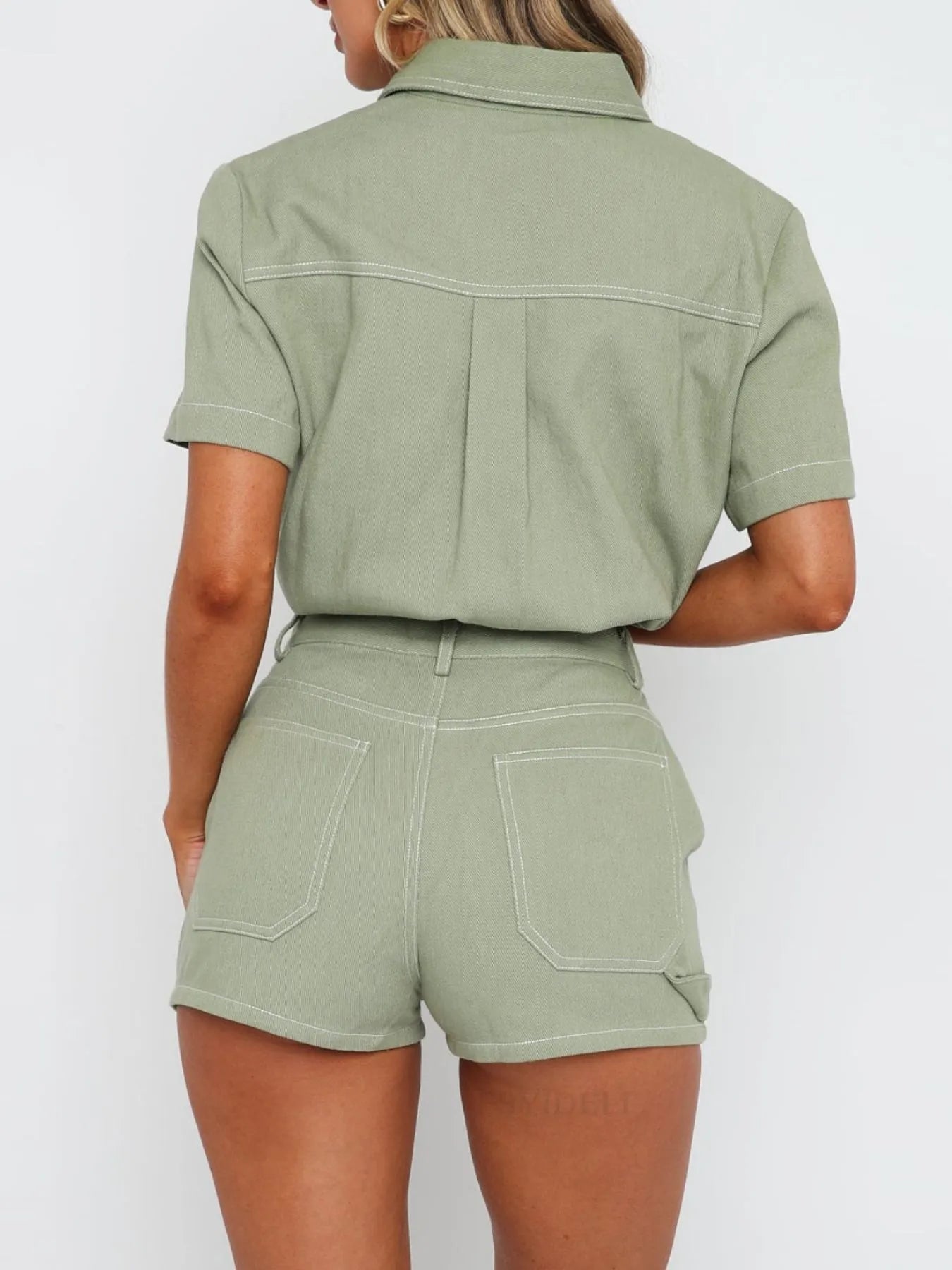 Model wearing matching button-up denim top and shorts set in sage back view