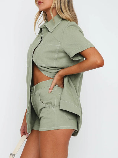 Model wearing matching button-up denim top and shorts set in sage side view