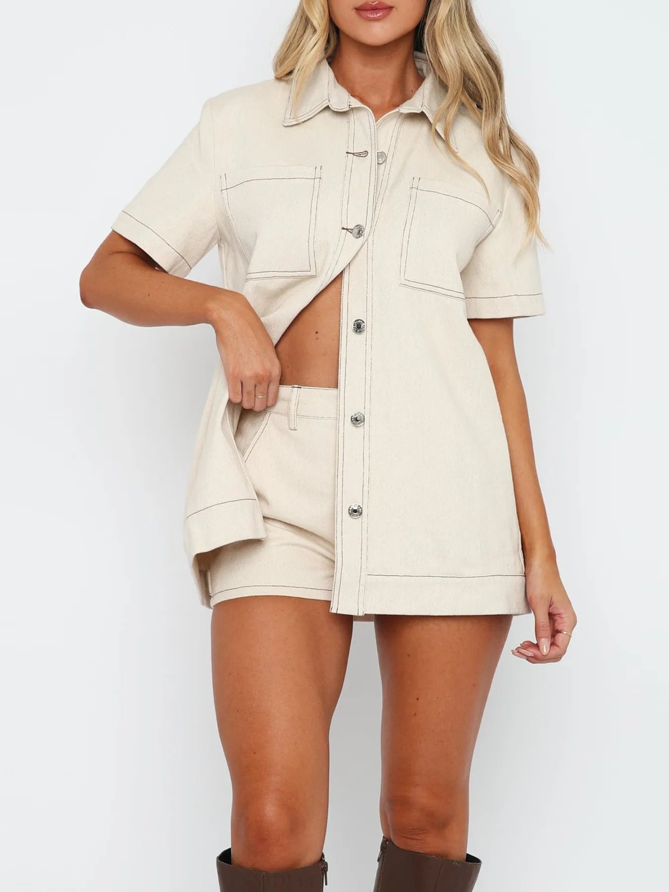 Model wearing white matching button-up denim top and shorts set