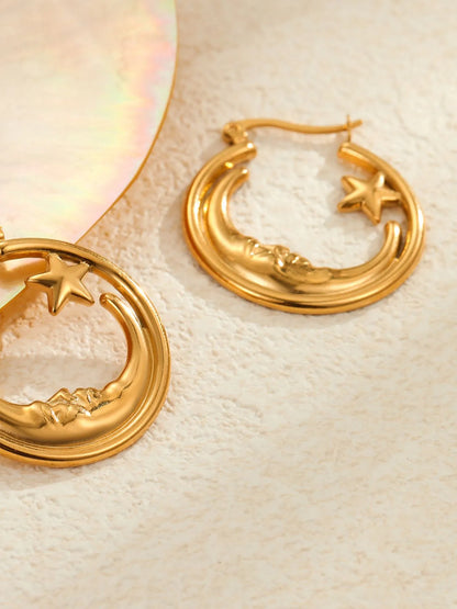 18K gold plated moon and star charm hoop earrings on flat surface