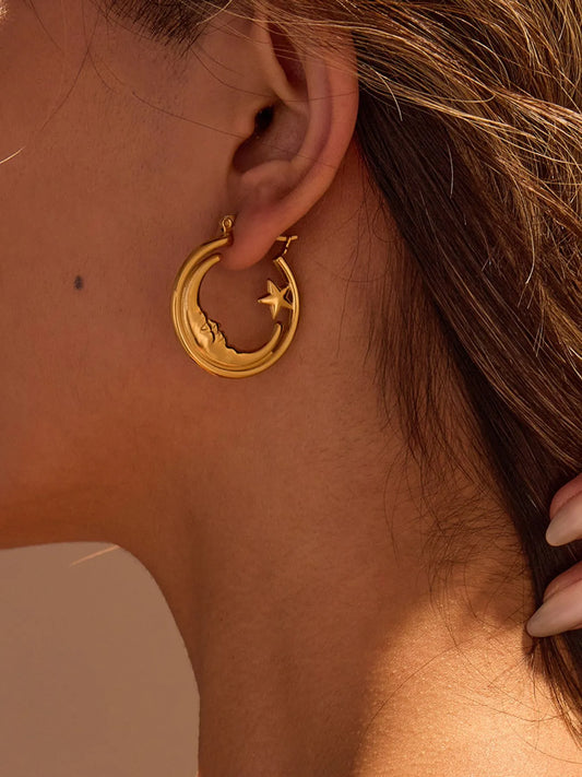 Woman wearing 18K gold plated moon and star charm celestial hoop earrings side view