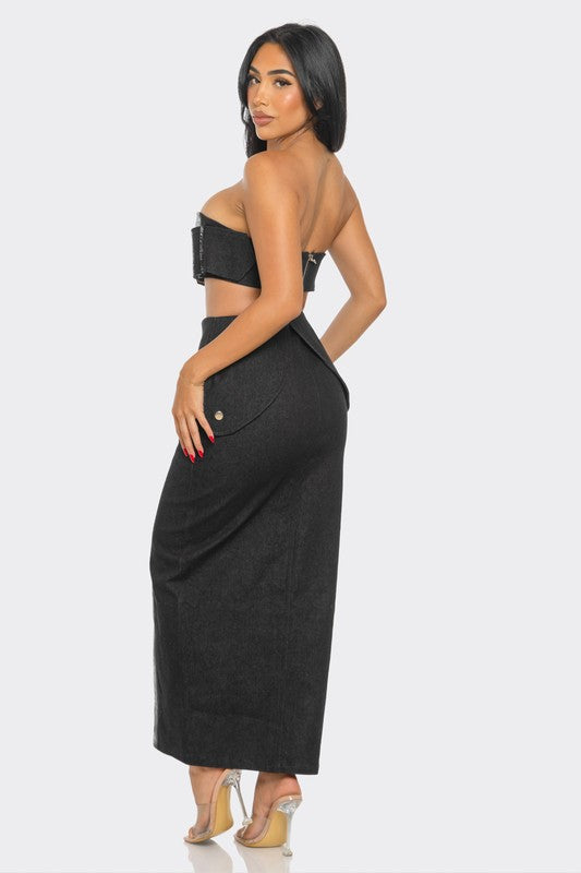 Woman wearing a metallic abstract print  strapless top and convertible high-waisted denim midi skirt set on a white background back view