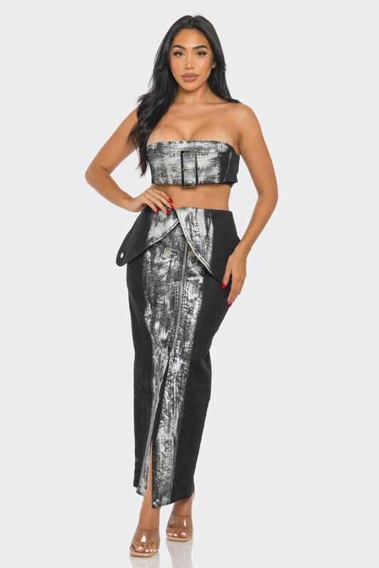 Woman wearing a metallic abstract print  strapless top and convertible high-waisted denim midi skirt set on a white background front view