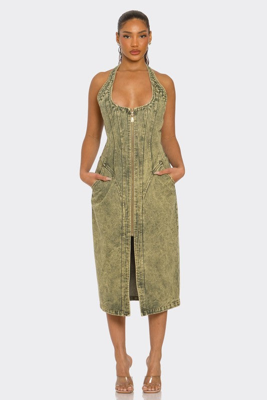 woman wearing a Y2K inspired  green acid wash halter denim midi dress with backless design and front slit 