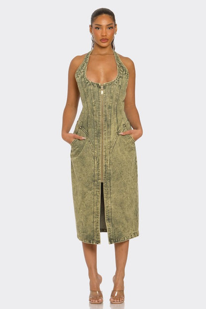 woman wearing a Y2K inspired  green acid wash halter denim midi dress with backless design and front slit 