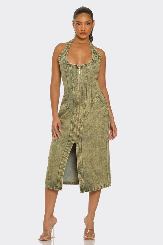 Woman wearing a green high quality denim midi dress with front zipper and slit  on a white background