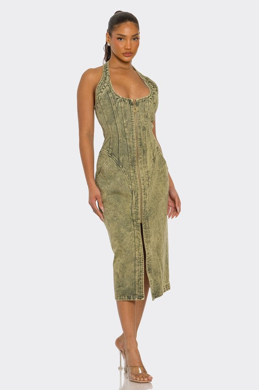 Woman wearing a green acid wash Halter denim midi dress with backless design and front slit on a white background