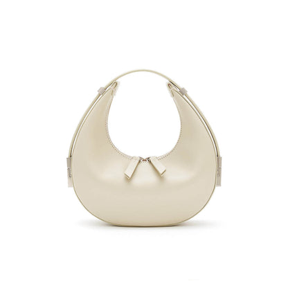 beige/off white mini crescent shoulder genuine leather handbag with zipper closure on a white background