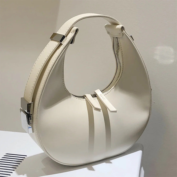 Modern beige/off white genuine leather hobo-style mini crescent handbag with zip closure