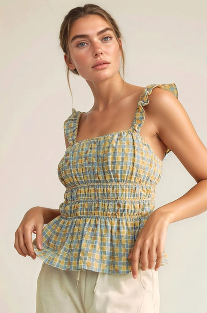 Model wearing plaid smocked top with ruffle straps front view