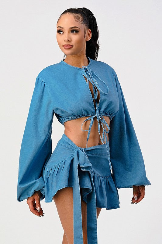 woman in a  stylish denim two piece coordinated crop top and ruffle skirt set 