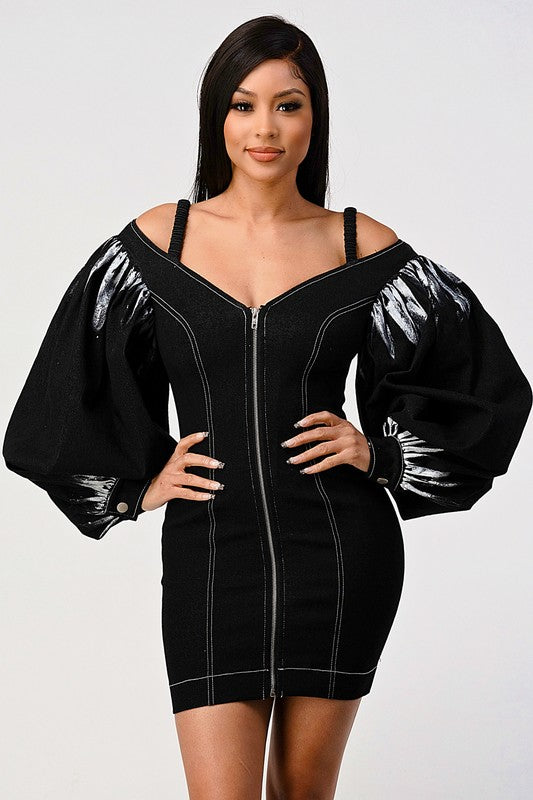 woman wearing a black front zip-up black denim bodycon mini dress with off-shoulder neckline and lantern tie dye long sleeves 