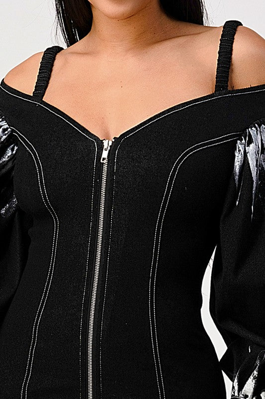 close up of off shoulder neckline and zipper front of a black denim mini bodycon dress for women 