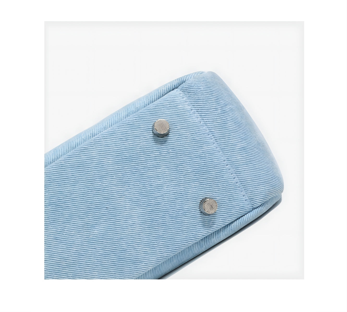 View of four anti slip spikes of light blue Denim & Genuine Leather Contrast Tote Bag on a white background