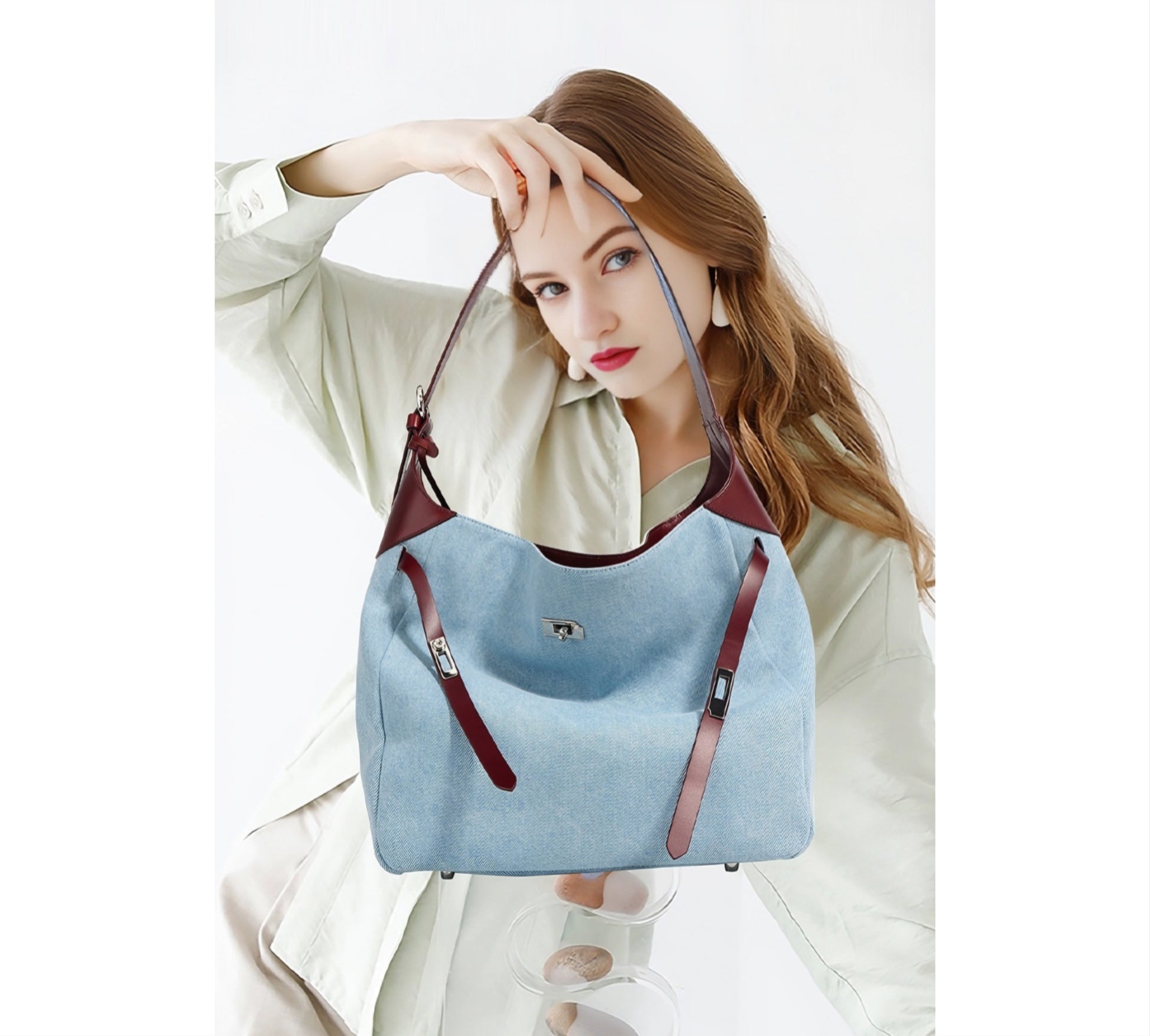 Woman holding a Denim & Genuine Leather Contrast Tote Bag against a white background