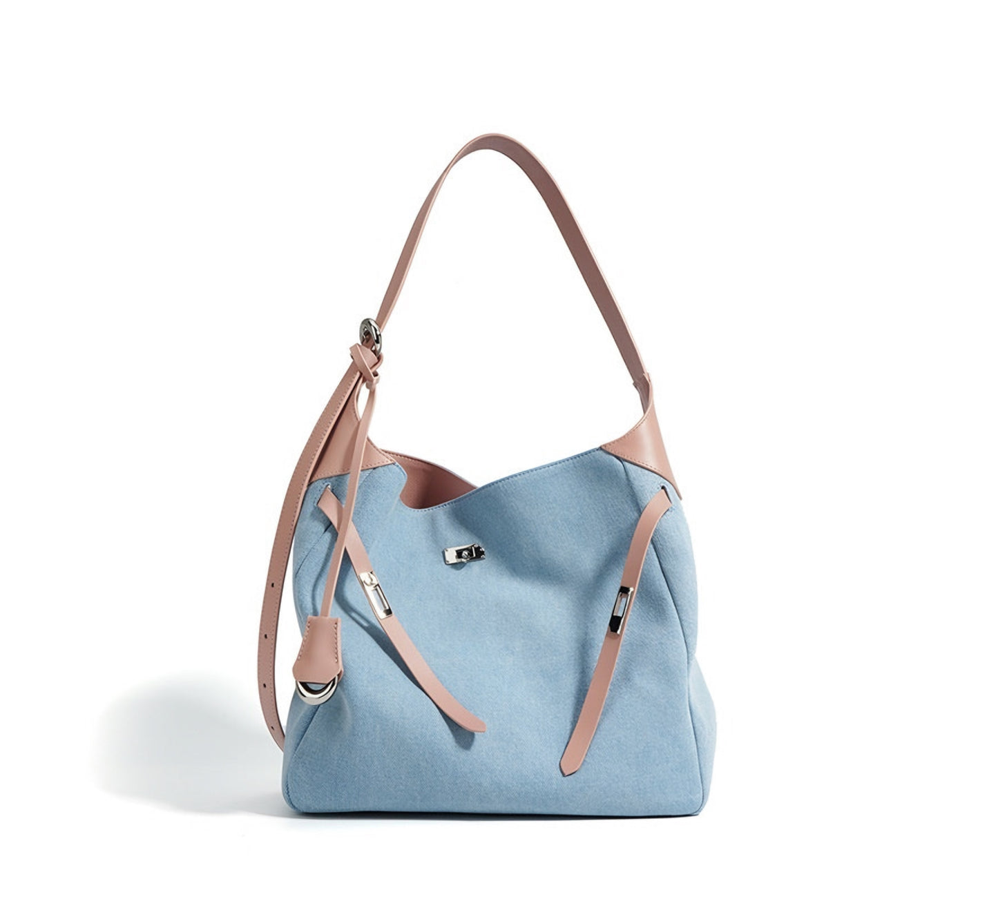 Light blue denim shoulder tote handbag with pink genuine leather straps on a white background
