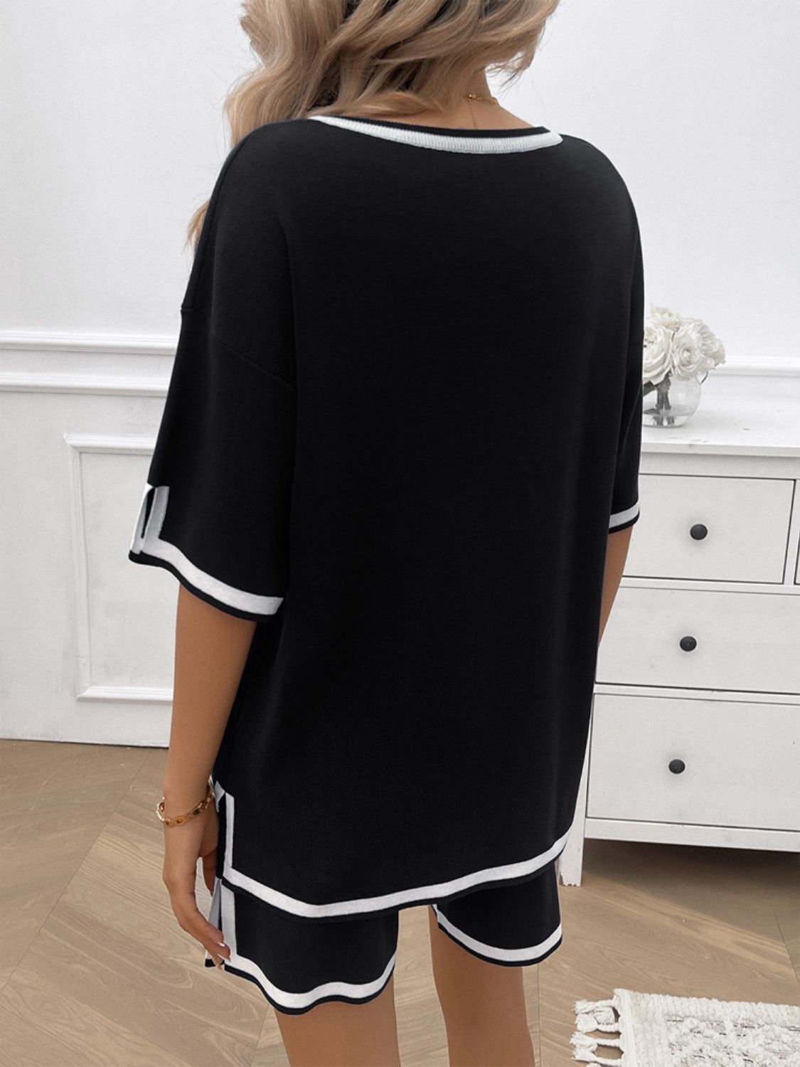 Casual two-piece summer outfit with shorts and top in black on model back view