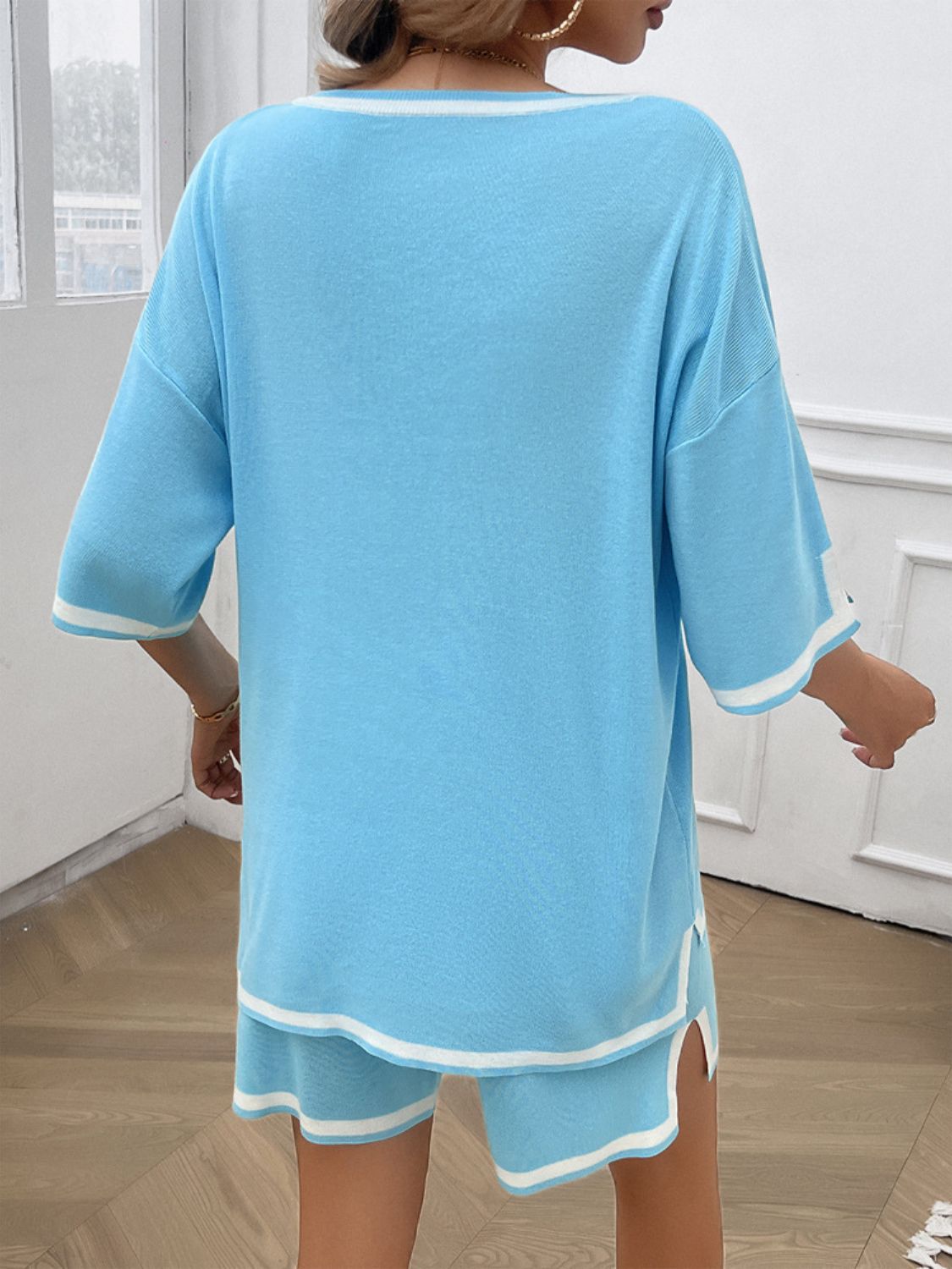 Casual summer outfit with V-neck top and shorts in pastel blue on model back view