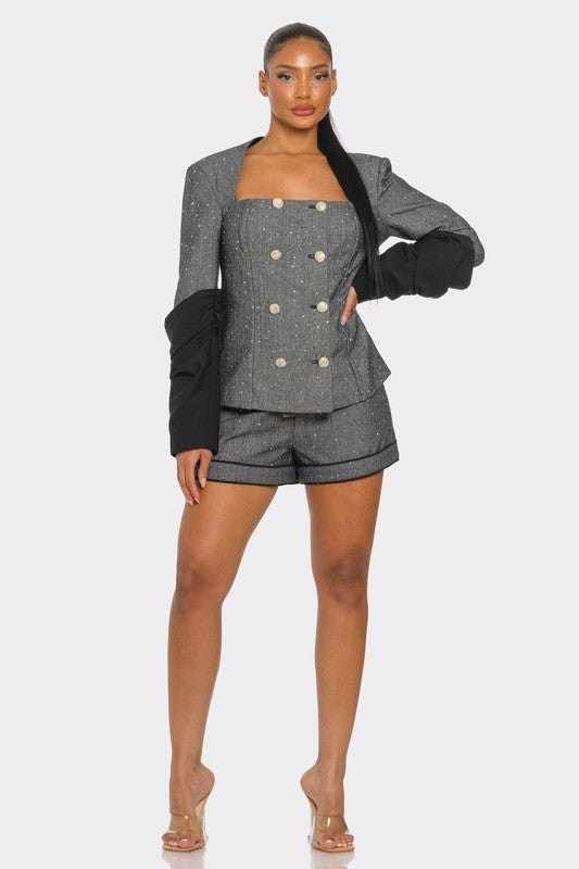 woman wearing a gray and black elegant tweed two piece blazer and shorts high end stylish ensemble 