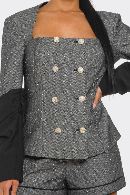 close up view of high quality tweed blazer and high waist shorts in black and gray color with button front and shimmer detail closure for women event wear 