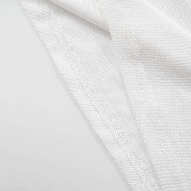Close-up of hem stitching of white sleeveless asymmetrical top with metal clasp