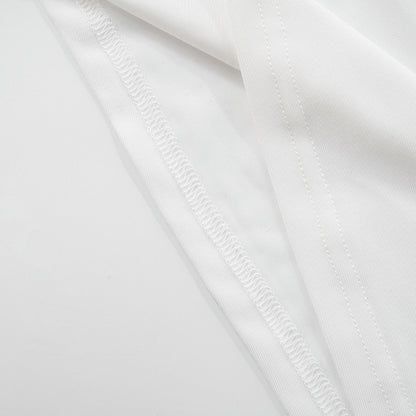 Close-up of hem stitching of white sleeveless asymmetrical top with metal clasp