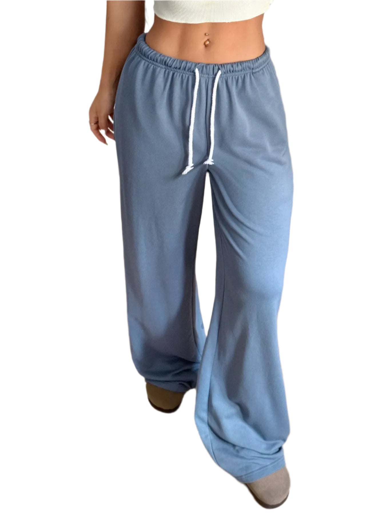 Woman wearing blue high rise wide leg sweatpants with a white drawstring on a white background
