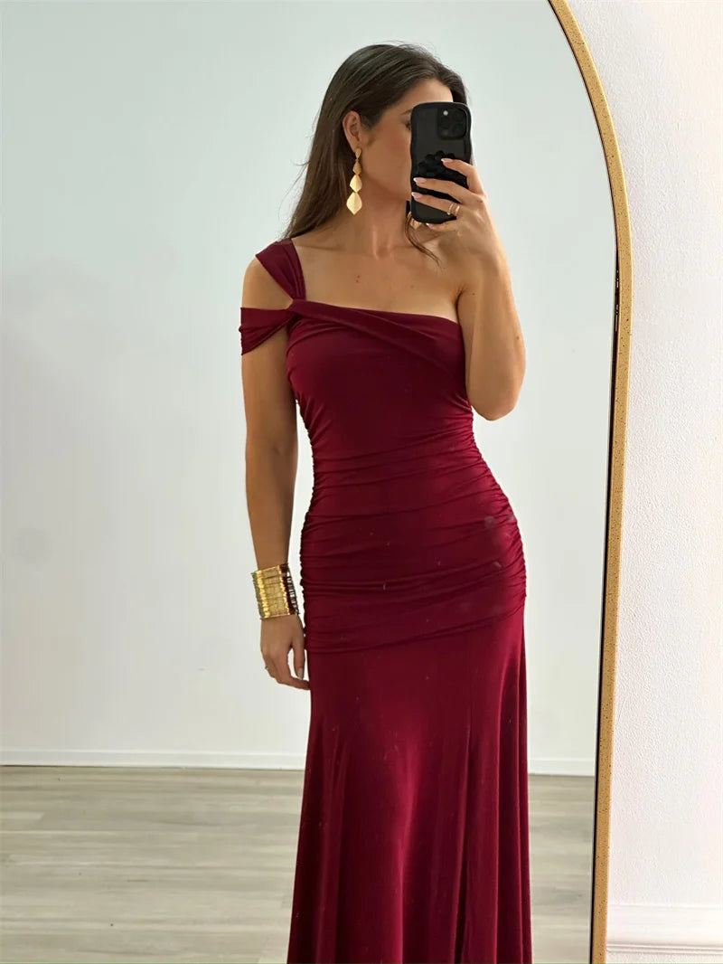 Model wearing elegant one-shoulder bodycon burgundy evening dress

