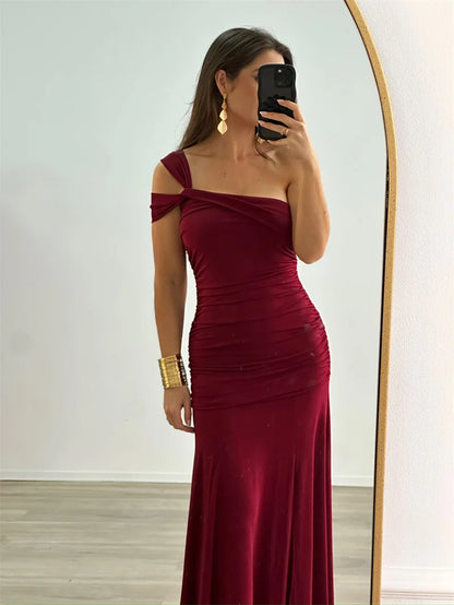 Model wearing elegant one-shoulder bodycon burgundy evening dress

