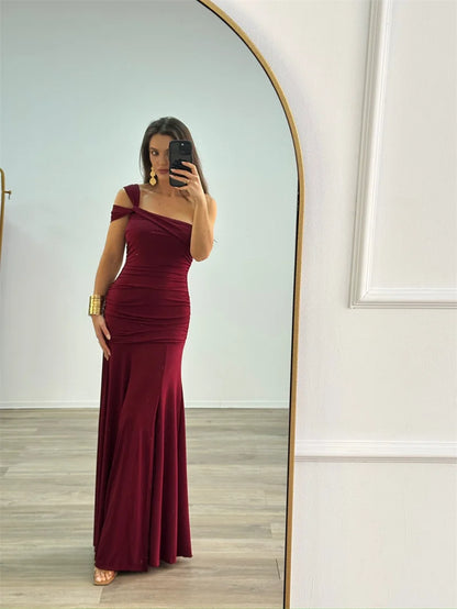 woman wearing elegant one-shoulder bodycon burgundy maxi dress

