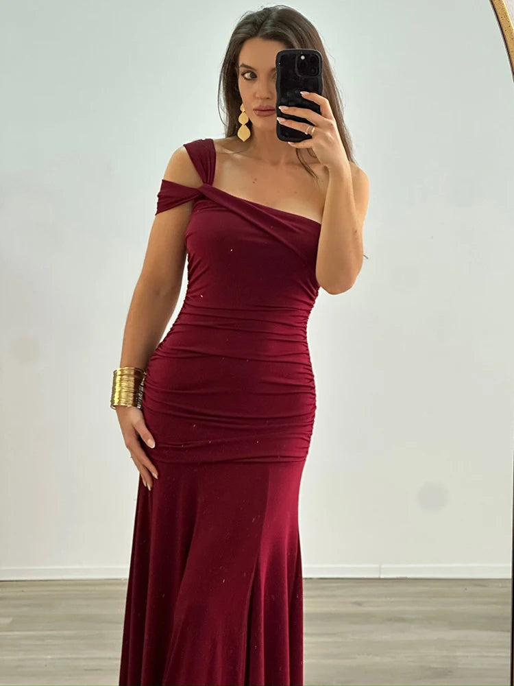 Model wearing elegant one-shoulder bodycon maxi dress in burgundy red


