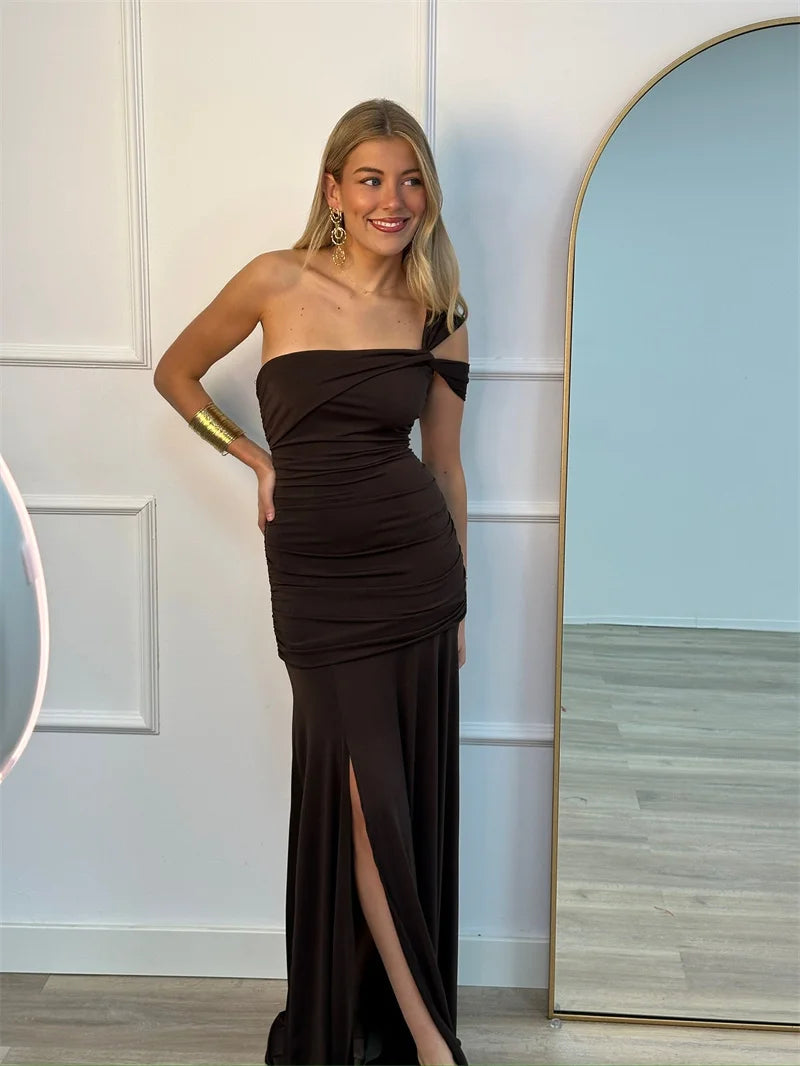 Woman wearing elegant one-shoulder  bodycon dark brown formal evening maxi dress
