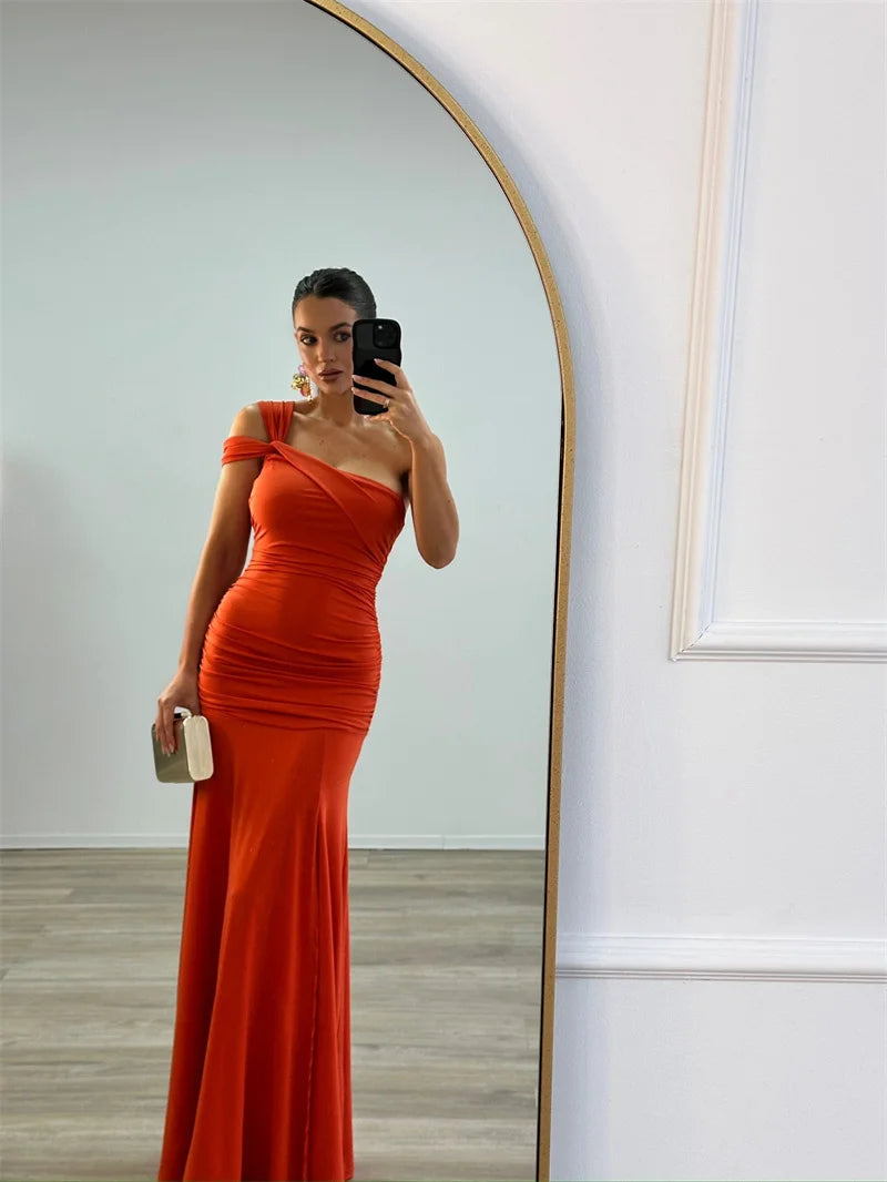 Model wearing elegant one-shoulder  asymmetrical bodycon orange maxi dress

