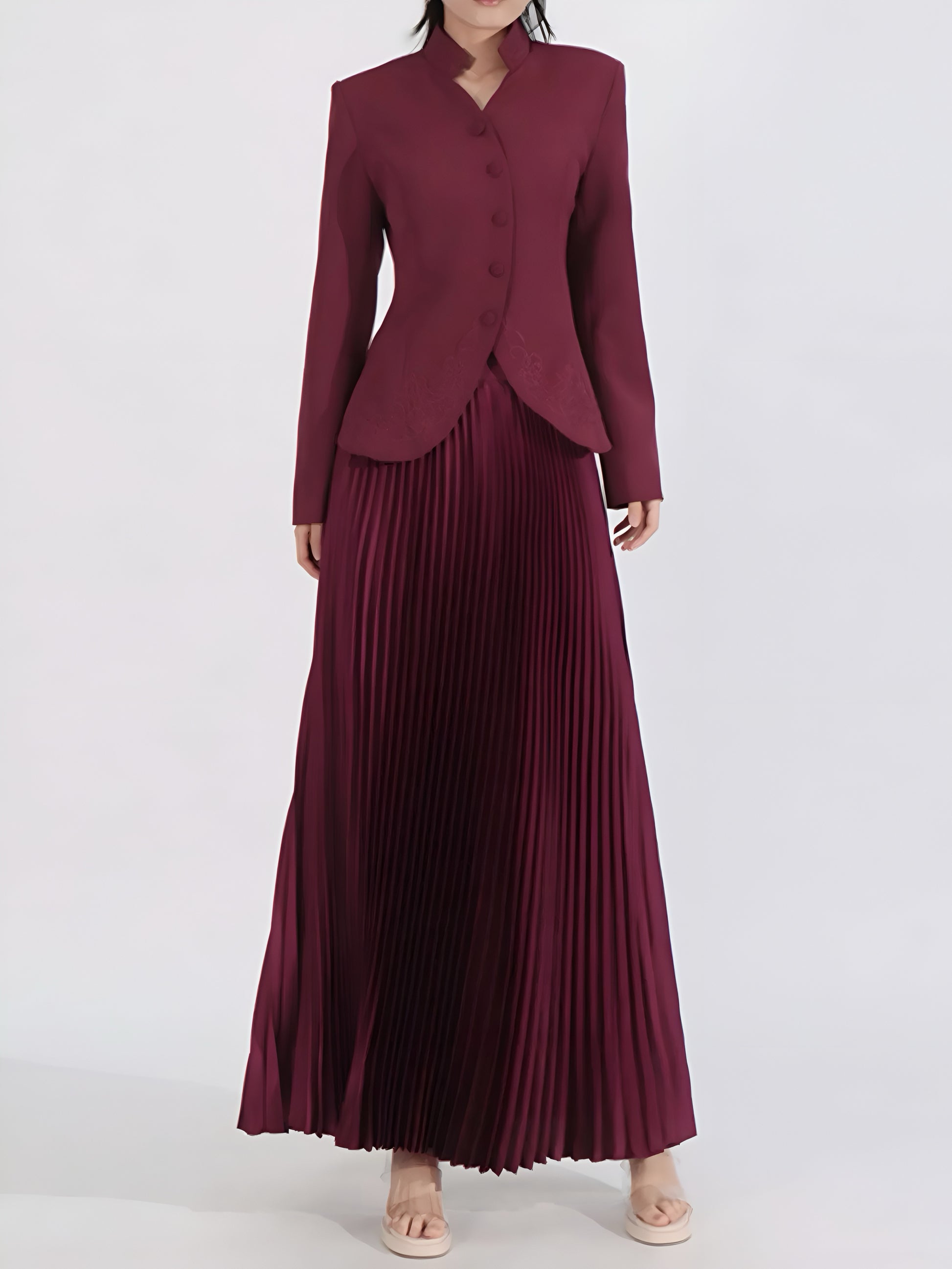 Woman wearing a burgundy button-up jacket and pleated maxi skirt women’s co-ord set